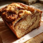 Close-up of a freshly baked Amish cinnamon bread loaf with swirls of cinnamon sugar.