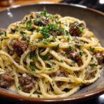 A close-up of delicious Beef and Garlic Butter Linguine pasta, topped with fresh parsley and grated cheese.