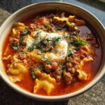 Close-up of a hearty bowl of Lasagna Soup, featuring pasta, rich tomato sauce, ground meat, and melted cheese.