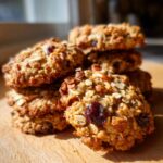 A stack of delicious Nut and Seed Energy Cookies, featuring oats, dried cranberries, and nuts.