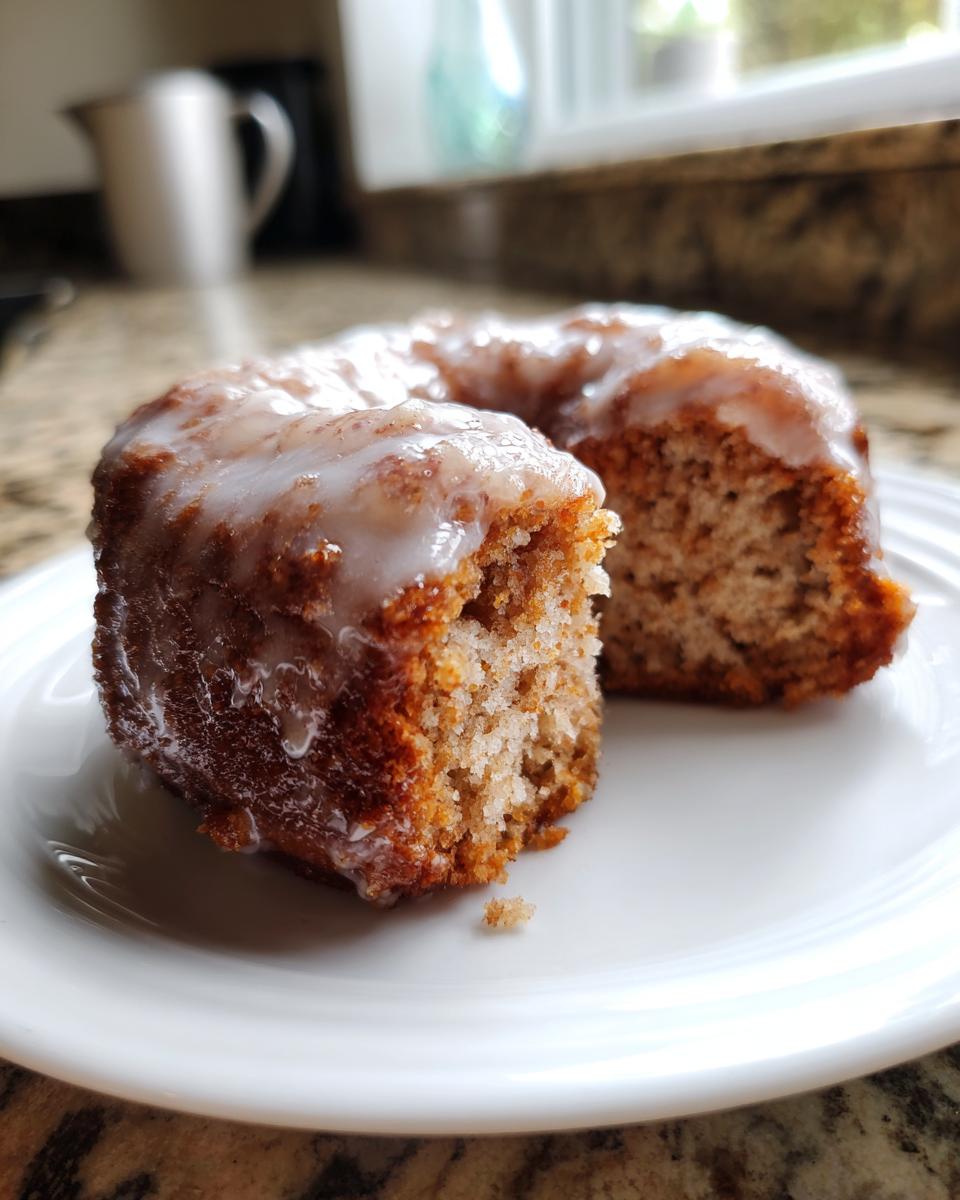 Close-up of a buttermilk donut bar with a sweet glaze, showing its fluffy interior.