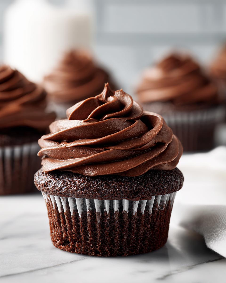 Close-up of a perfectly frosted easy chocolate cupcake with swirls of rich chocolate frosting.