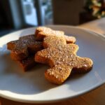 Close-up of soft gingerbread cookies shaped like people, sprinkled with coarse sugar.
